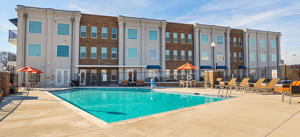 The Lofts at Southside pool area with umbrellas and lounge chairs