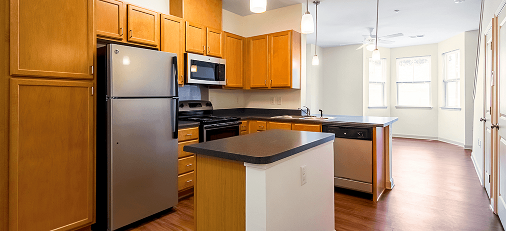 a kitchen with stainless steel appliances and wooden cabinets