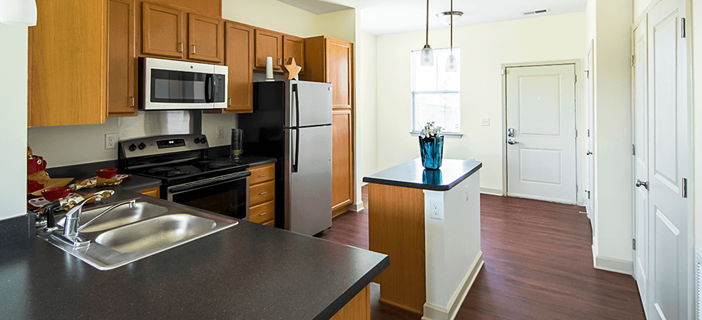 a kitchen with stainless steel appliances and wooden cabinets