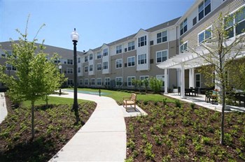 Sidewalk view of apartment buildings-Senior Living at Cambridge Heights Apartments, St. Louis, MO - Photo Gallery 3