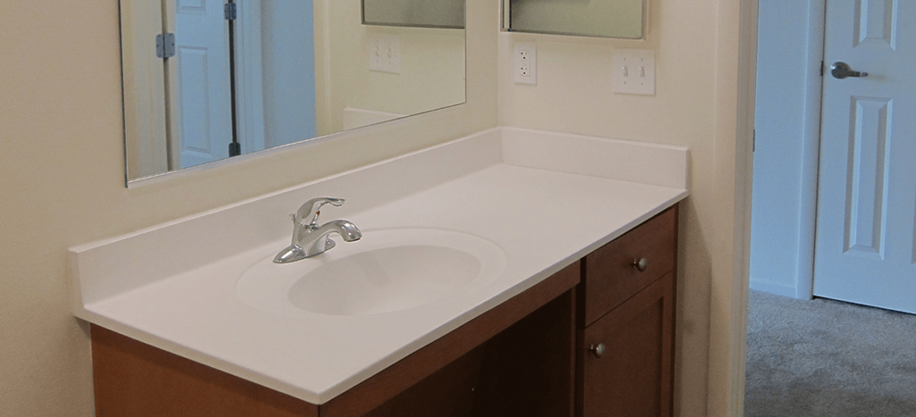 an empty bathroom with a sink and a mirror at MacArthur Park Apartments