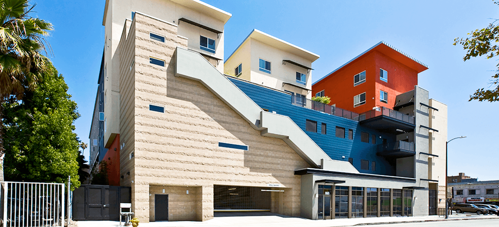 MacArthur Park Apartments; a building with a staircase that is painted blue and orange