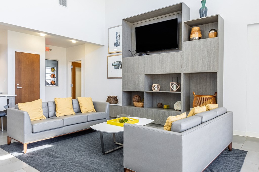 a community room with couches and a television at Marrero Commons Apartments & Townhomes