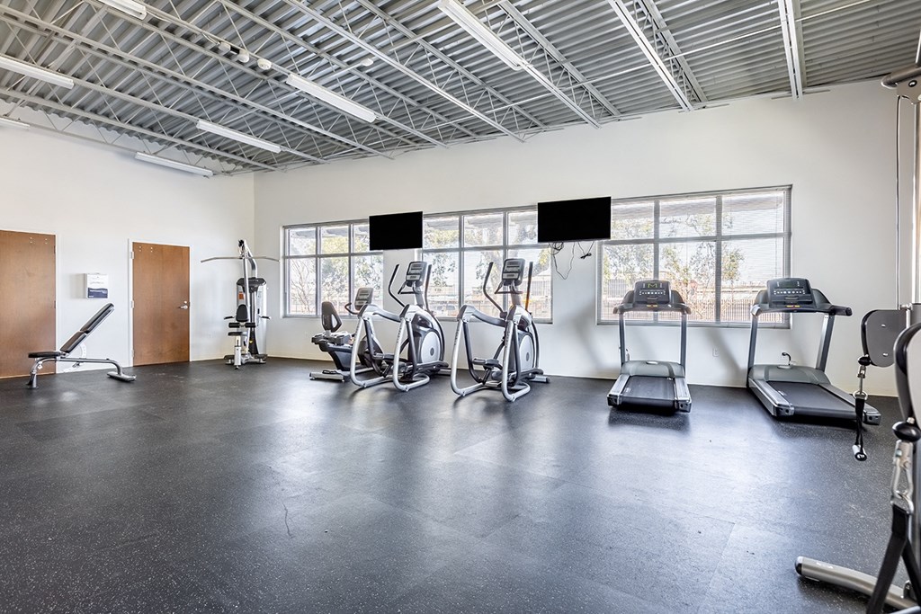 the gym has plenty of treadmills and other exercise equipment at Marrero Commons Apartments & Townhomes