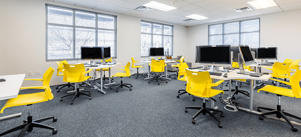 Marrero Commons Apartments business center with yellow chairs and computers