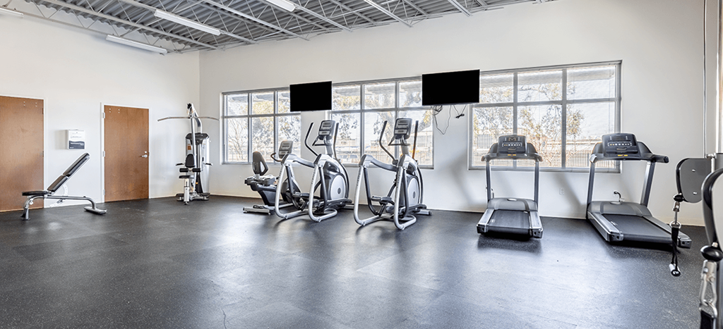 a fitness room with treadmills and other exercise equipment at Marrero Commons Apartments