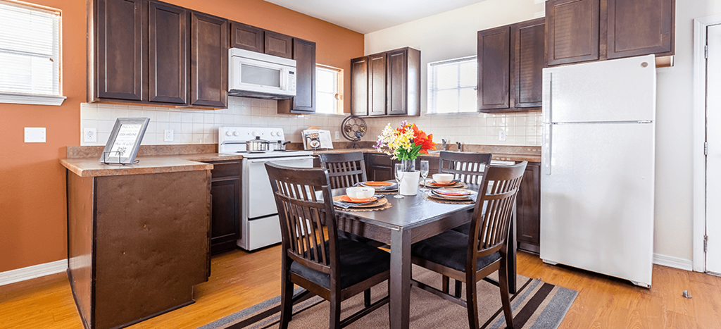 a kitchen and dining room with a table and chairs