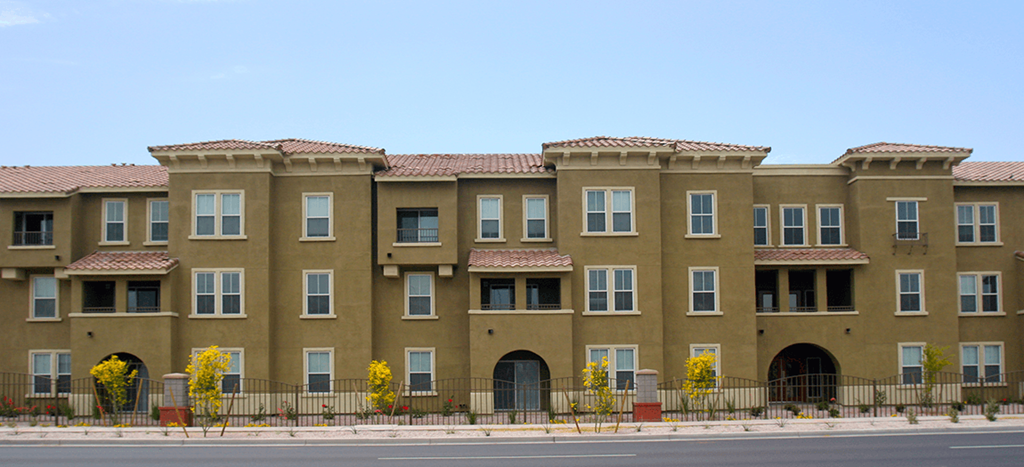 a row of apartment buildings on the side of a street