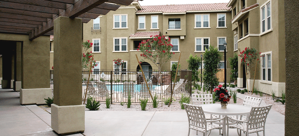 a patio with tables and chairs at Senior Living at Henson Village