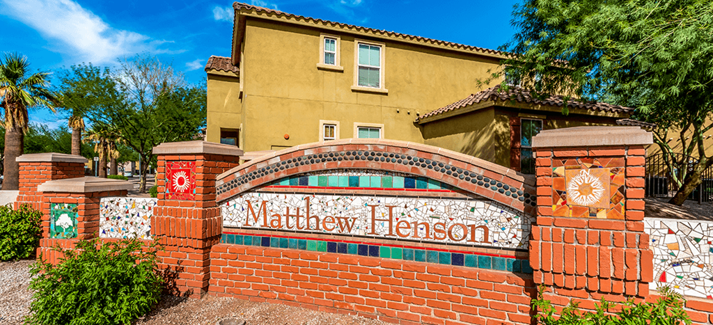a brick wall with a sign in front of a building