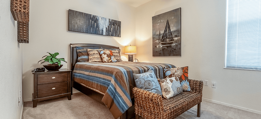 the model primary bedroom at Matthew Henson Apartments