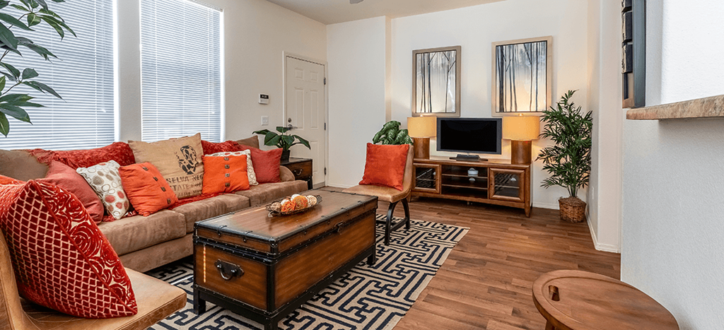 a living room with a couch and a tv at Matthew Henson Apartments