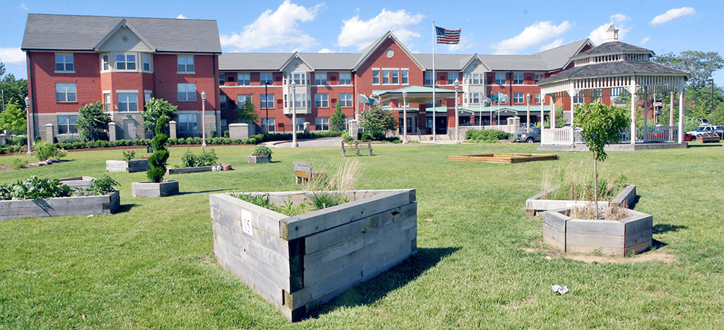 an outdoor garden in front of an apartment building
