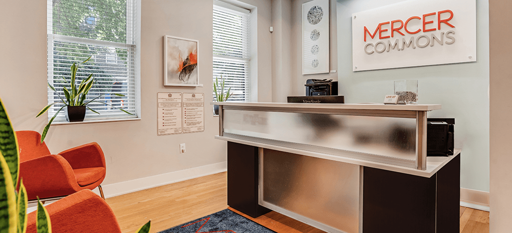 an office with a desk and a chair and a window at Mercer Commons Apartments
