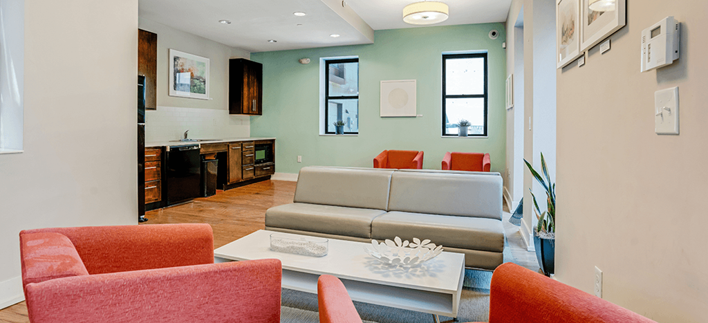 a Clubhouse with a couch and a coffee table at Mercer Commons Apartments