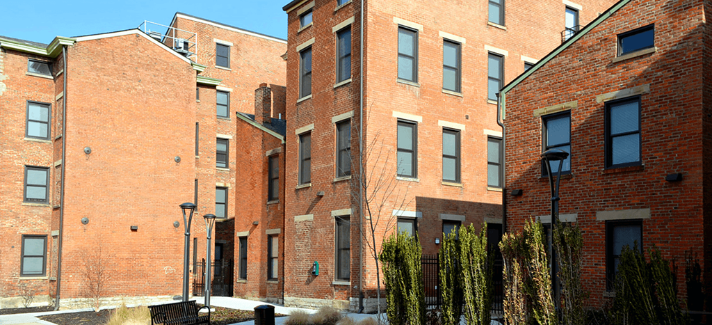 a row of brick apartment buildings on a city street