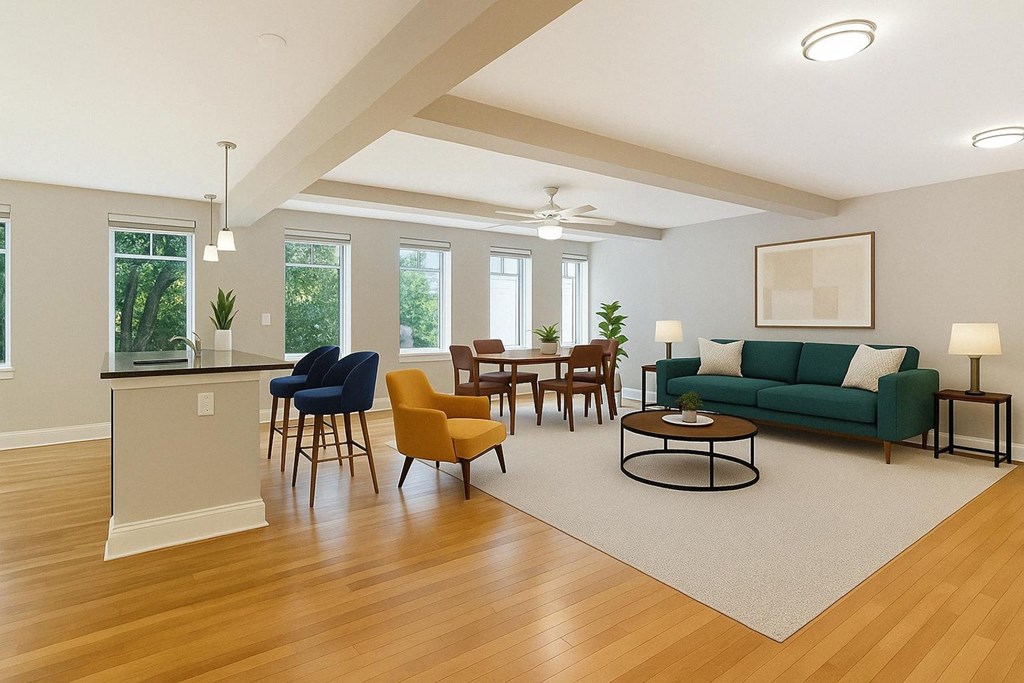 A living room with a green couch and wooden floors.