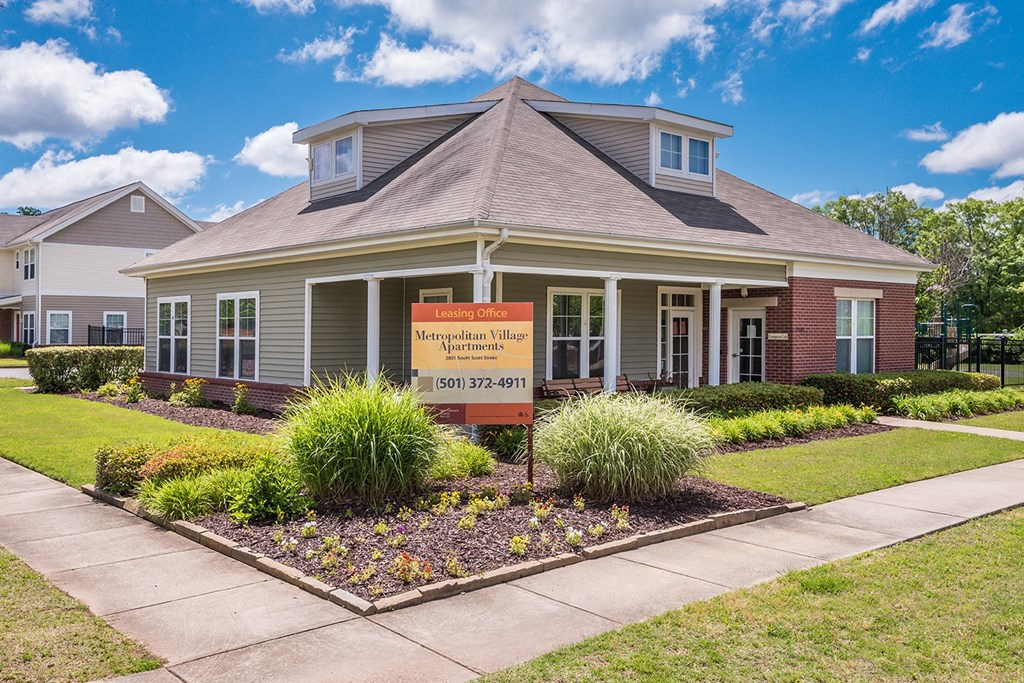 a leasing office with a sign in front of it Cumberland Manor and Metropolitan Village Apartments and Townhomes in Little Rock, AR.