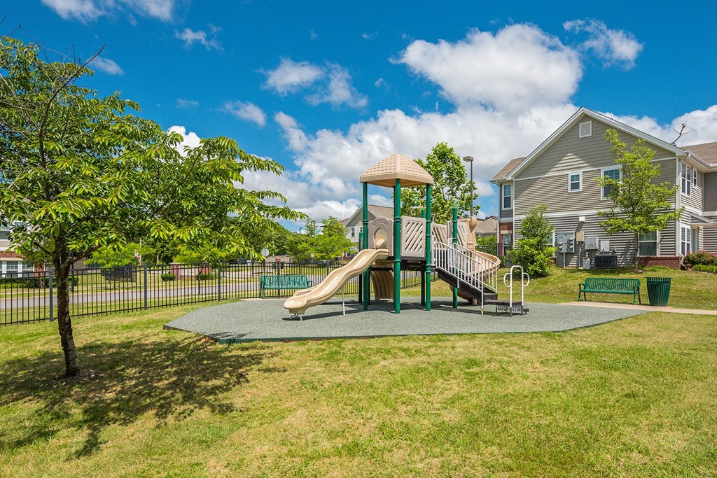 A beige and green playground at Cumberland Manor and Metropolitan Village Apartments and Townhomes in Little Rock, AR.