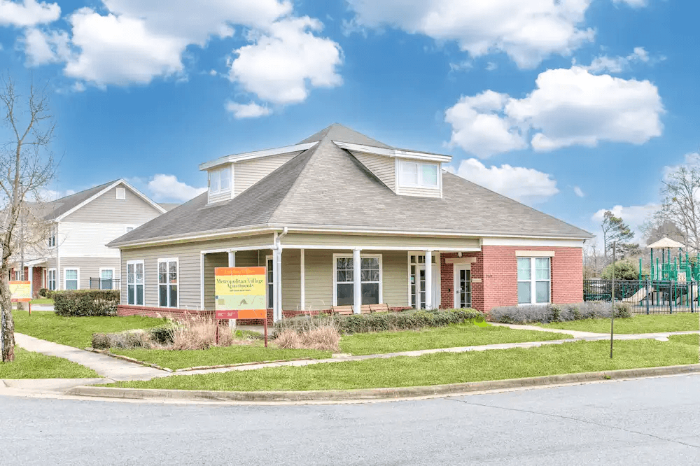 A house with a sign in front of it.
