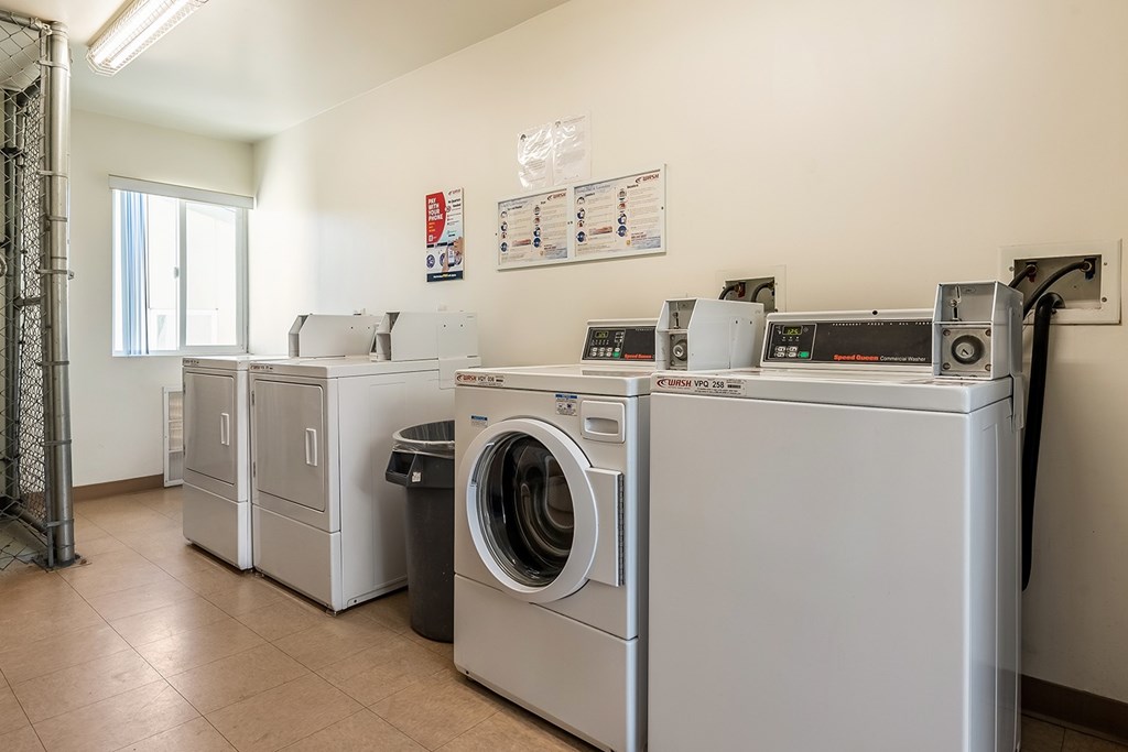 A laundry room with washers and dryers.