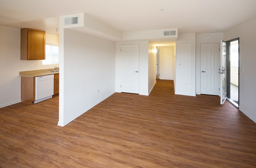 A room with wooden floors and white walls.