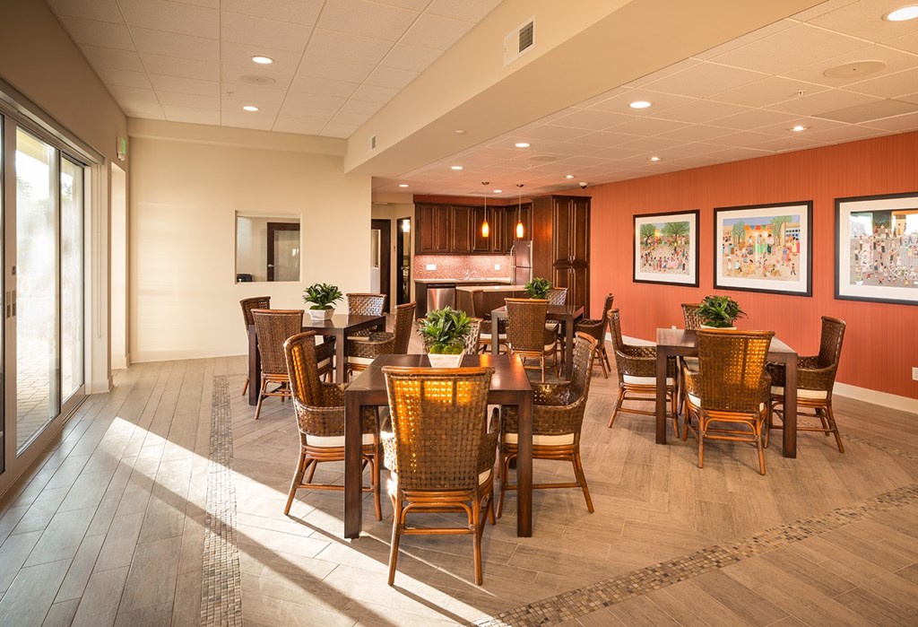 A dining room with wooden floors and chairs.
