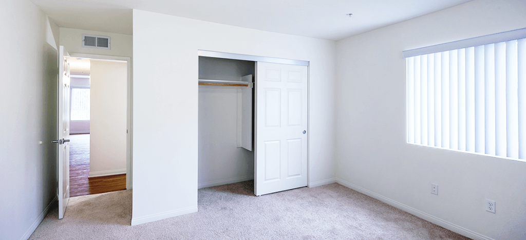 Mission Plaza Apartments; bedroom with a closet and an open door