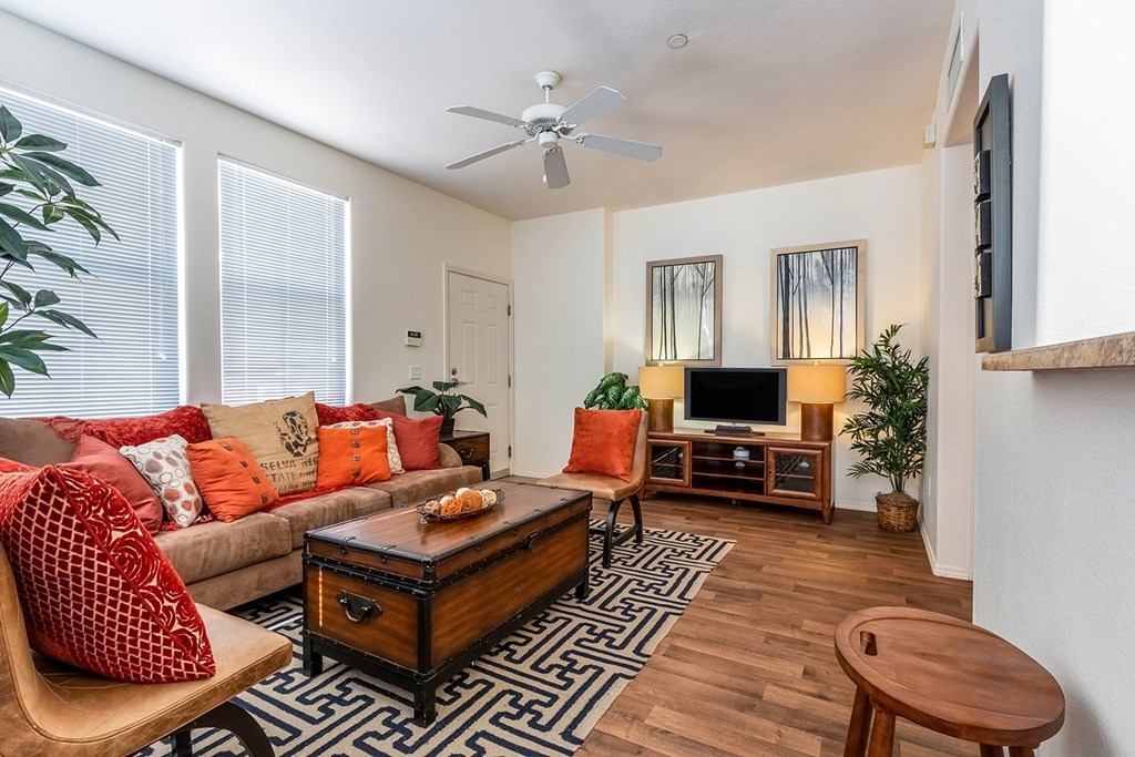 A living room with a brown wooden coffee table and a brown chair.