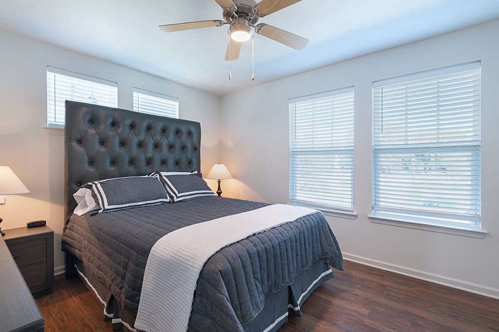 a bedroom with a large bed and a ceiling fan