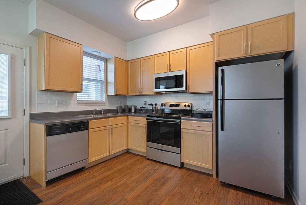 a kitchen with stainless steel appliances and wooden cabinets