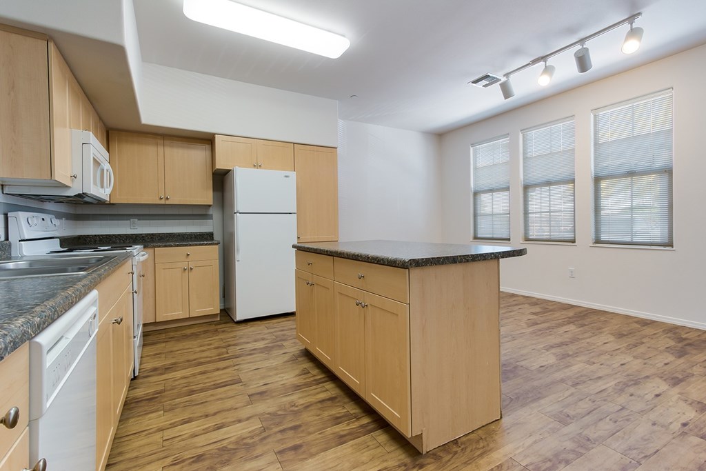A kitchen with wooden cabinets and a white refrigerator.