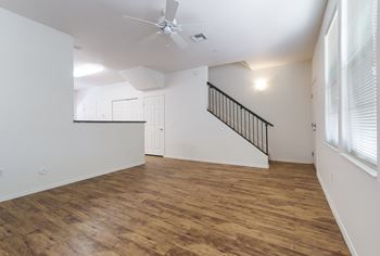 A room with wooden floors and a staircase.