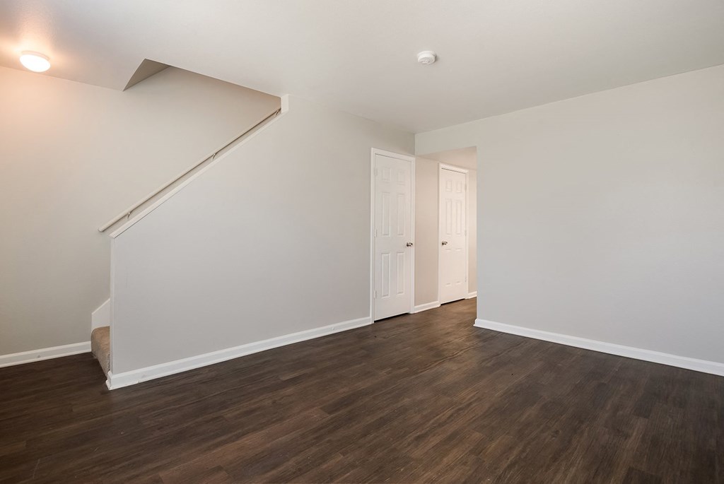 A room with a staircase and two doors.