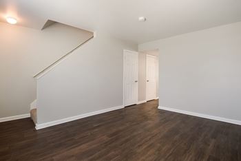 A room with a staircase and two doors.