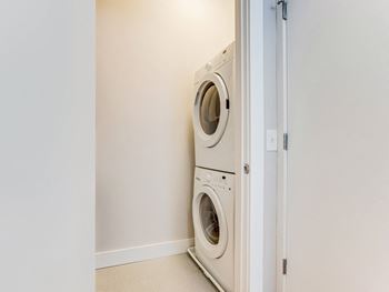 a front loading washer and dryer in a laundry room