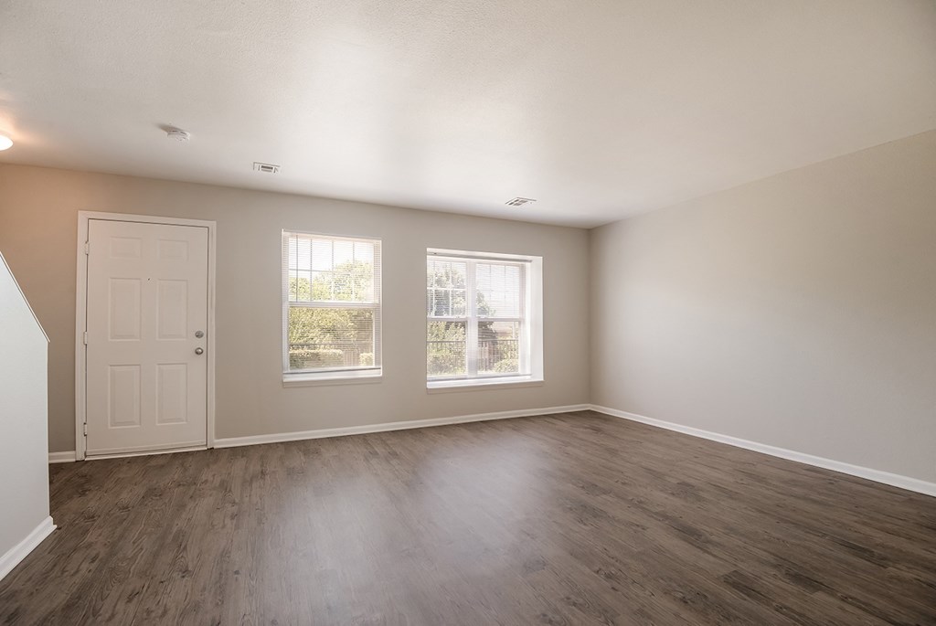 Empty room with wooden floors and white walls.