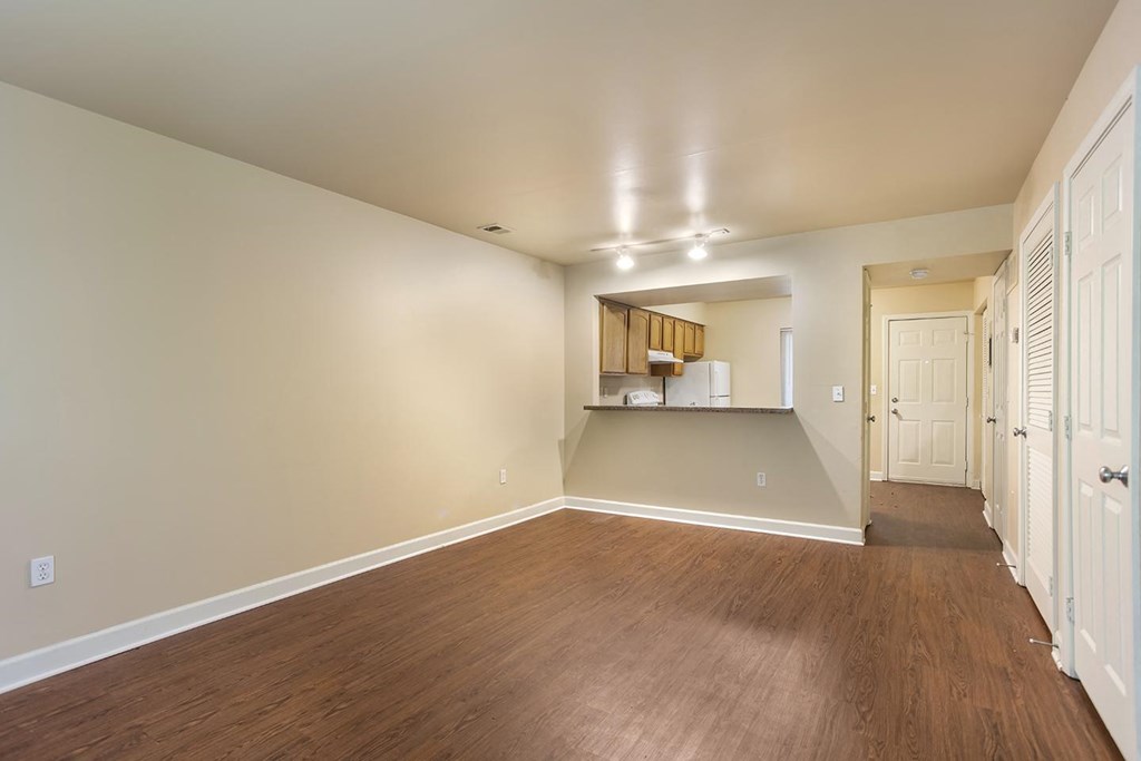 A room with wooden floors and white walls.