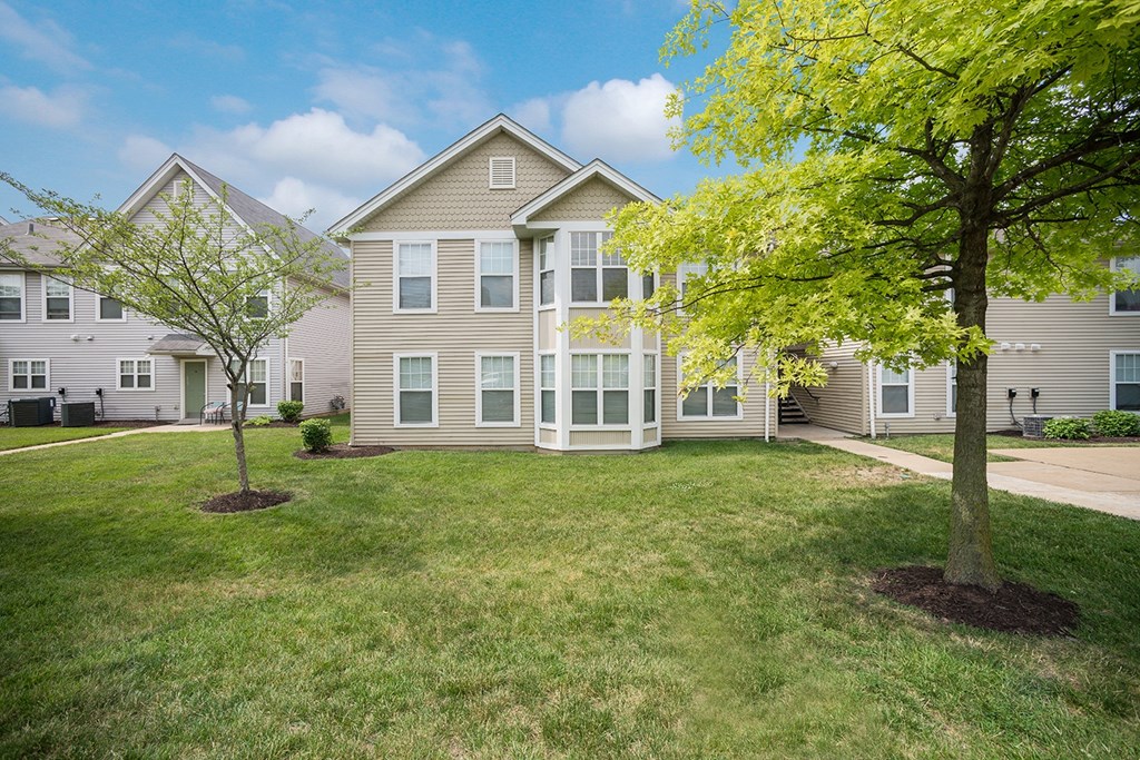 the view of a house with trees in front of it