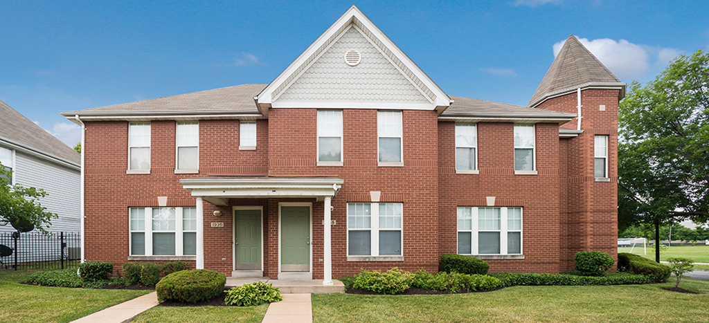 a brick apartment home with a sidewalk in front of it at Murphy Park Apartments
