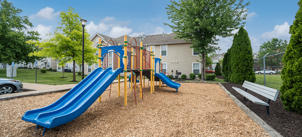 the playground with two blue slides at Murphy Park Apartments