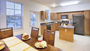 A kitchen with a table set for a meal.