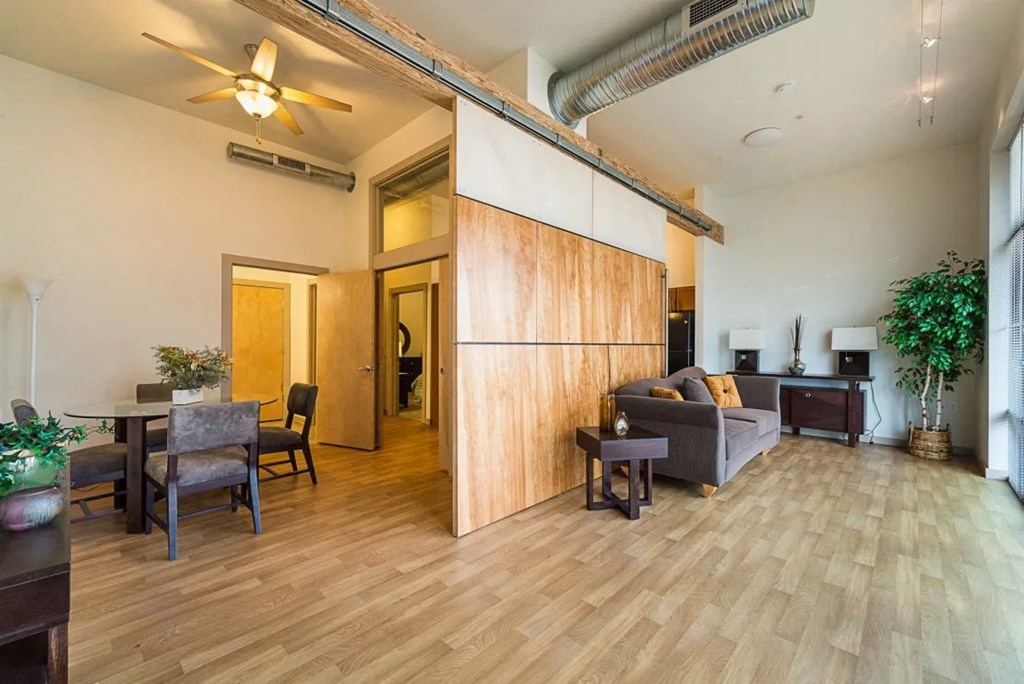a living room and dining room with a wood floor