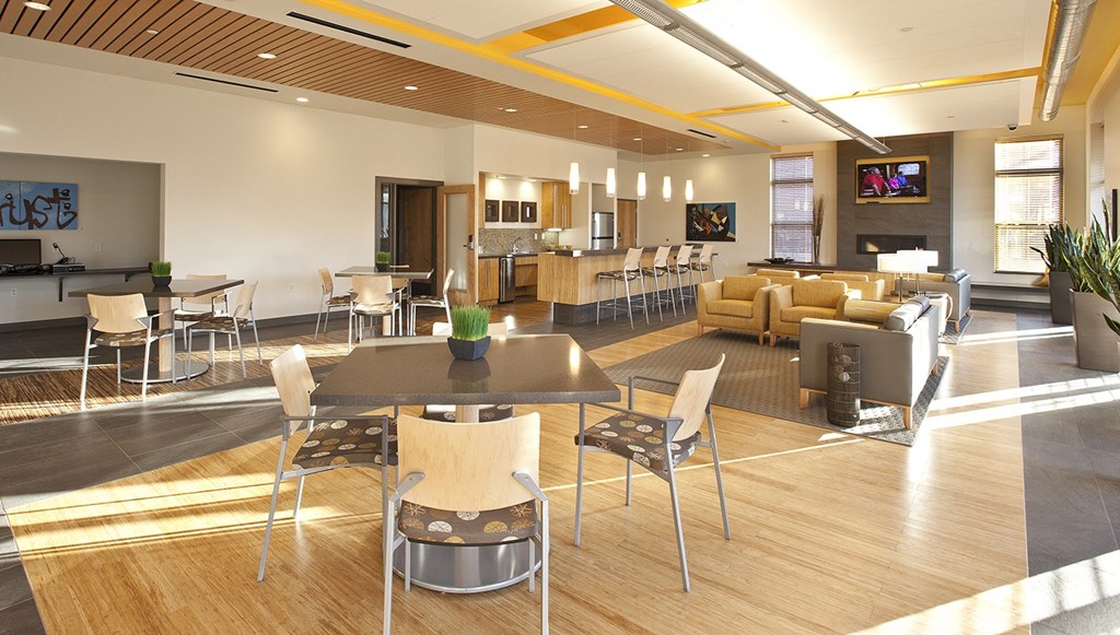 a rendering of the lobby of a hotel with tables and chairs