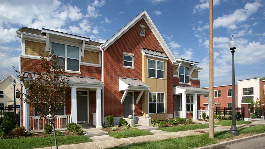 a row of brick homes on the side of a street