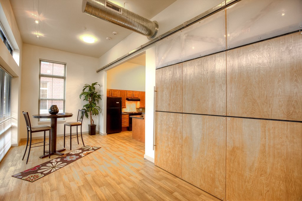 a dining room with a table and chairs and a refrigerator