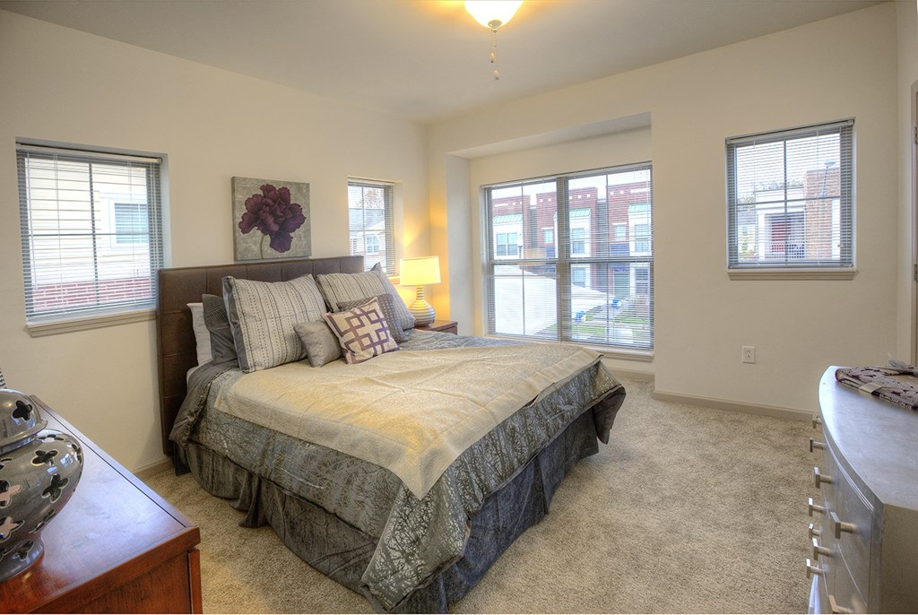 a bedroom with a large bed and a window