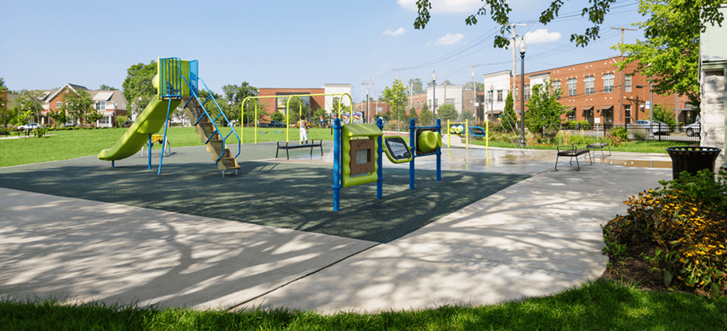 a playground in a park on a sunny day at North Sarah Apartments
