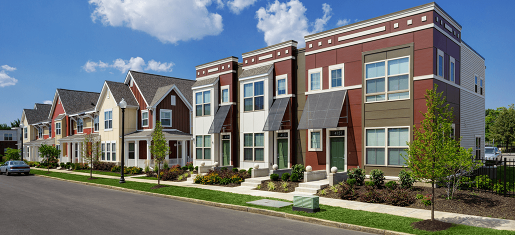 a row of townhouses in front of a street at North Sarah Apartments