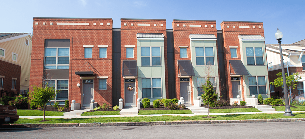 a row of brick apartment buildings on a city street